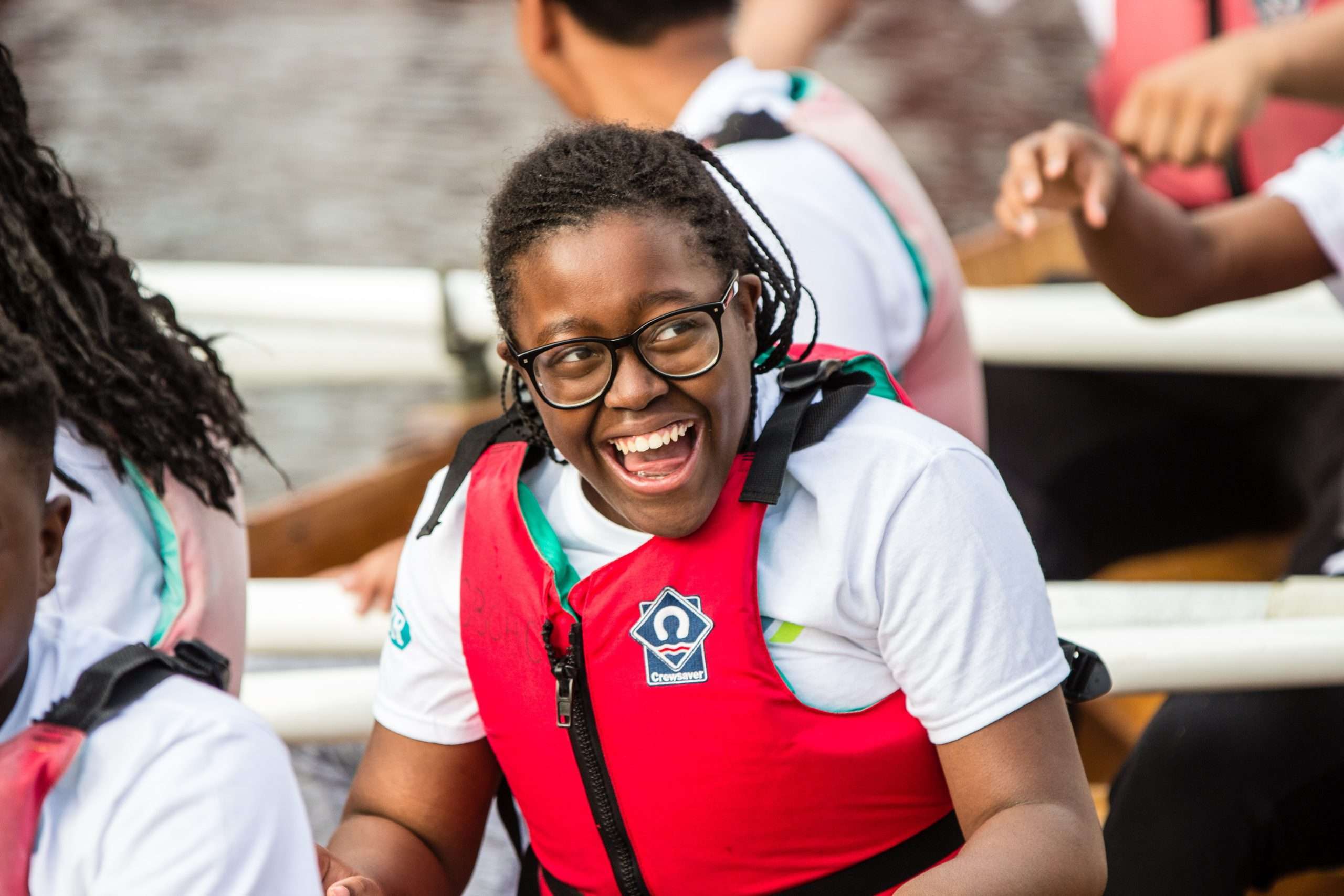 A young person rowing at Canada Water Dock