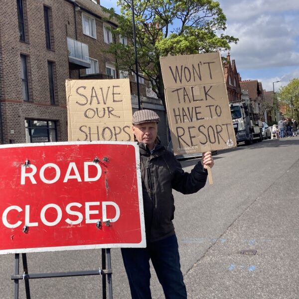 Residents and businesses protest for third time over proposal to remove parking